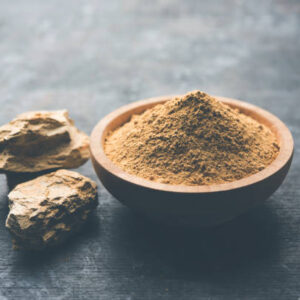 Fuller'S Earth Clay OR Multani mitti in a bowl along with raw stones and mortar