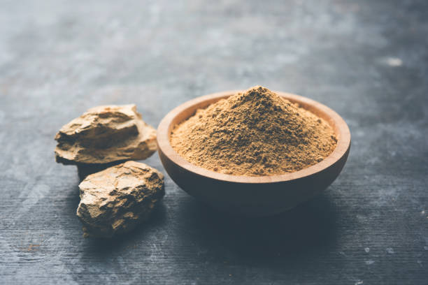 Fuller'S Earth Clay OR Multani mitti in a bowl along with raw stones and mortar